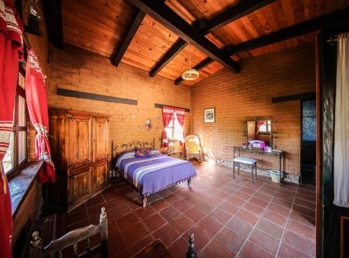 a bedroom with a bed in a wooden room at Huayápam Yù'ú Lodge in San Andrés Huayapan