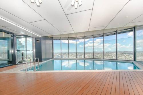 a large swimming pool with a view of a city at AirTrip Apartment on Margaret Street in CBD in Brisbane