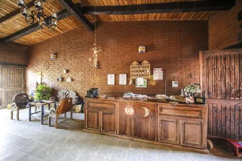 a room with a wooden counter and a brick wall at Huayápam Yù'ú Lodge in San Andrés Huayapan