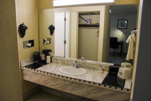 a bathroom with a sink and a large mirror at Days Inn by Wyndham Bend in Bend