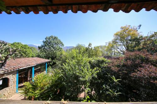 a view of a house with trees in the background at Huayápam Yù'ú Lodge in San Andrés Huayapan