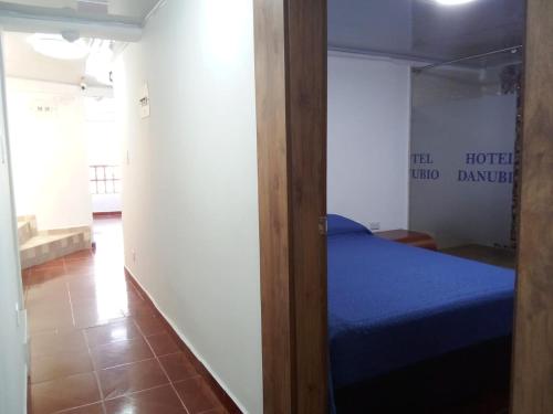 a room with a bed and a glass door at HOTEL DANUBIO in Bogotá