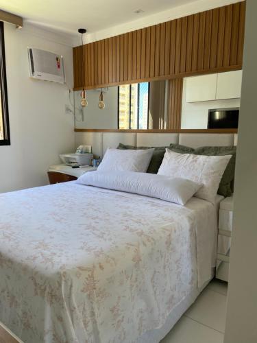 a bedroom with a large bed with white sheets at Belíssimo apartamento inteiro in Aracaju