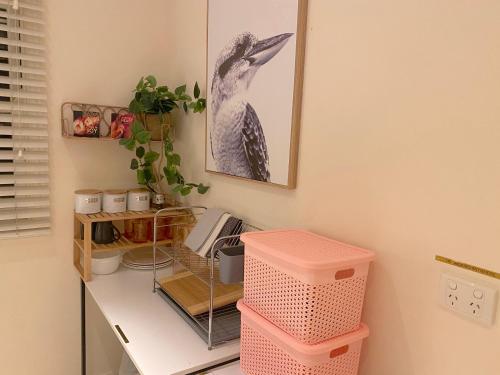 a room with a desk with a bird on the wall at Cosy Haven For Females Only or Females & Child/ren in Brisbane