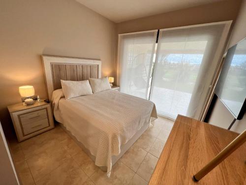 a bedroom with a bed and a large window at Destino Deluxe Valle del Este Vera in Vera