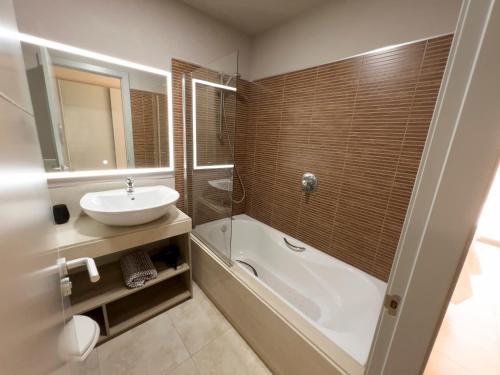 a bathroom with a sink and a tub and a toilet at Destino Deluxe Valle del Este Vera in Vera