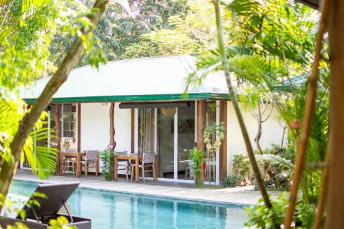 a villa with a swimming pool and a house at Cadlao Resort and Restaurant in El Nido