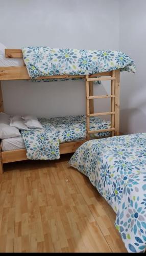a bedroom with two beds and a bunk bed at Finca Pradera Real in Circasia