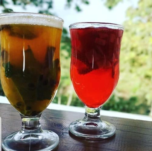 two drinks sitting on a wooden table at Finca Pradera Real in Circasia