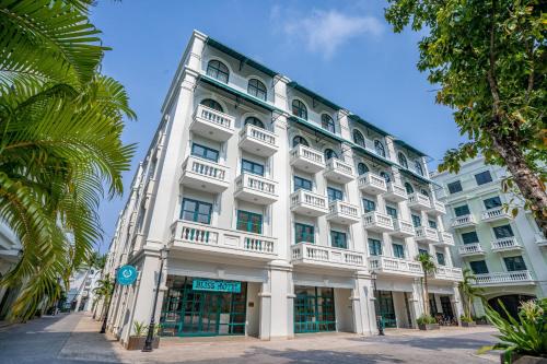 a large white building with a lot of windows at Bliss Hotel Phu Quoc in Phu Quoc