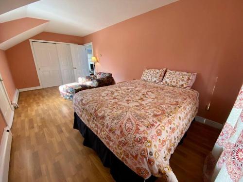 a bedroom with a bed and a chair in it at Peddlers Carriage house in New Hope