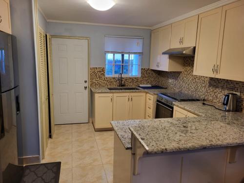 a kitchen with white cabinets and a counter top at Soleil Hartland 122 in Priory