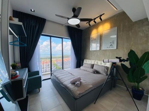 - une chambre avec un lit et un ventilateur de plafond dans l'établissement Orang Utan Guest House, à Sandakan