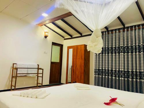 a bedroom with a bed with a veil on it at The River Villa in Talpe