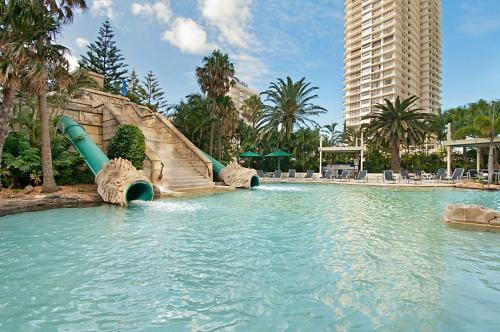 a water slide in a pool in a resort at Sun City Resort managed by Gchs in Gold Coast