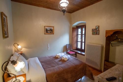 a bedroom with a large bed and a window at Casa Calda in Syrrako