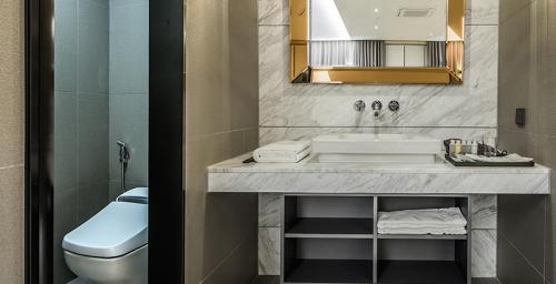 a bathroom with a sink and a toilet at Rivertain Hotel in Daegu