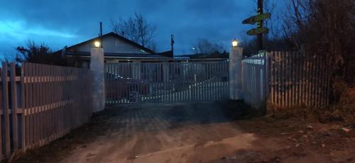a white fence with lights on top of it at Cabañas Campestres Las Rosas in Punta Arenas