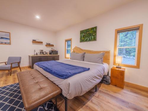 a bedroom with a large bed and a desk at Winter's Hideaway Suite in Ucluelet