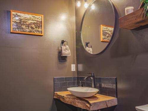 a bathroom with a sink and a mirror at Winter's Hideaway Suite in Ucluelet