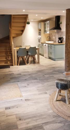 une grande cuisine avec une table et des chaises dans l'établissement Maison 2 chambres avec vue sur étang avec bain finlandais, à La Rivière-Saint-Sauveur