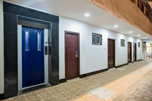 a row of doors in a hallway at IVY RESIDENCY in Coimbatore