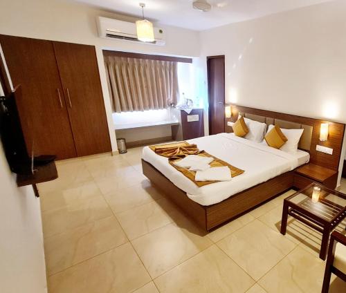 a hotel room with a bed and a television at SUN N SEA Resort in Diveagar