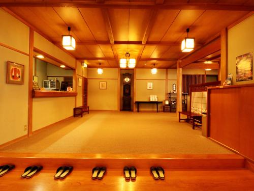 a large hall with shoes on the floor of a building at Kose Onsen in Karuizawa