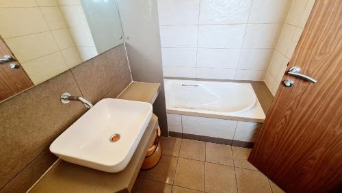 a small bathroom with a sink and a toilet at SUN N SEA Resort in Diveagar