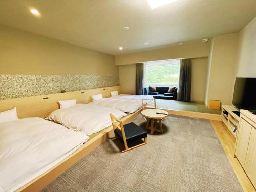 Postel nebo postele na pokoji v ubytování Grandvrio Hotel Unazukionsen