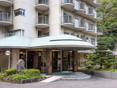a building with a large glass entry way at Shin Kabakawa Kanko Hotel in Takamatsu