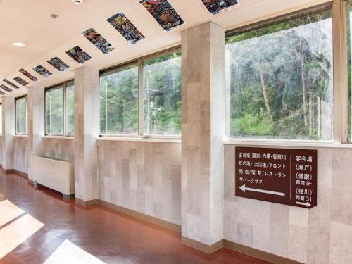 a room with windows and a sign on the wall at Shin Kabakawa Kanko Hotel in Takamatsu