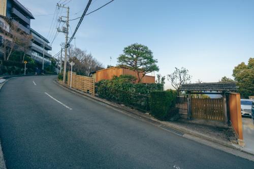 an empty street with a fence on the side of the road at Diamond・Yu　Atami in Ajiro