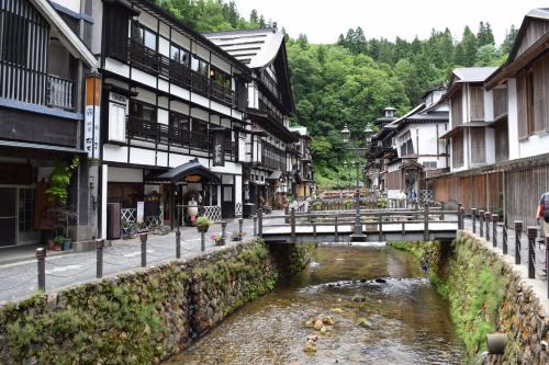 a bridge over a river in a town with buildings at Tendo Hotel in Tendo