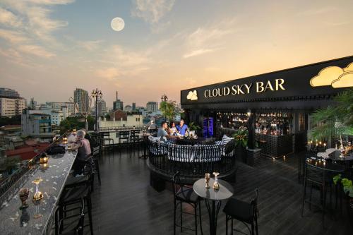 a bar with tables and chairs on a rooftop at JM Marvel Hotel & Spa in Hanoi