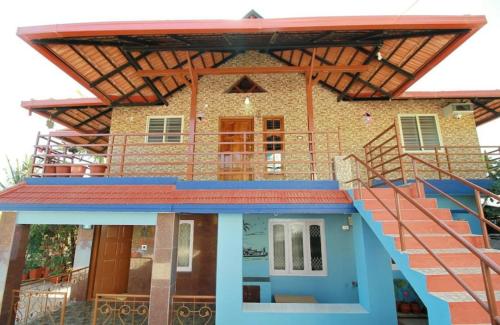 a house with stairs leading up to it at Hill View Homestay Madikeri Coorg 3BHK Villa in Madikeri