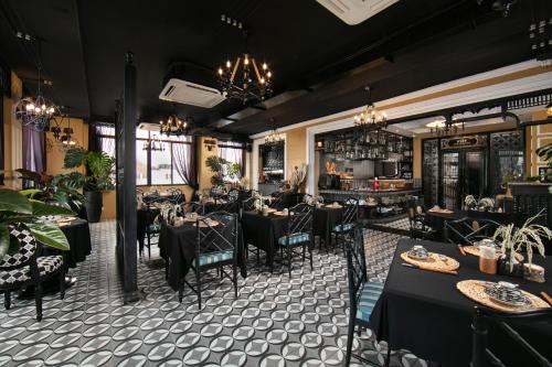 a dining room with tables and chairs and chandeliers at JM Marvel Hotel & Spa in Hanoi