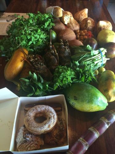 a table topped with a box of different types of fruits and vegetables at Kooyu Villas in Port Vila