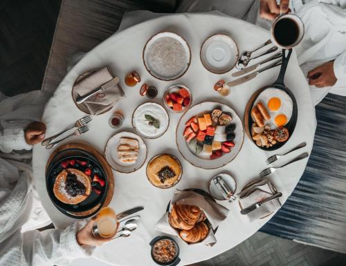 a table full of breakfast foods on a table at Four Seasons Hotel Kuwait at Burj Alshaya in Kuwait