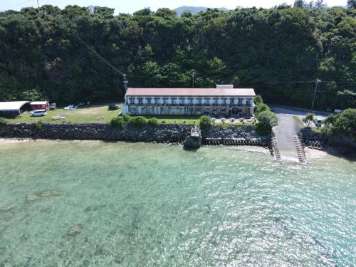 an aerial view of a building in the water at Hotel Oceans Nakijin in Nakijin