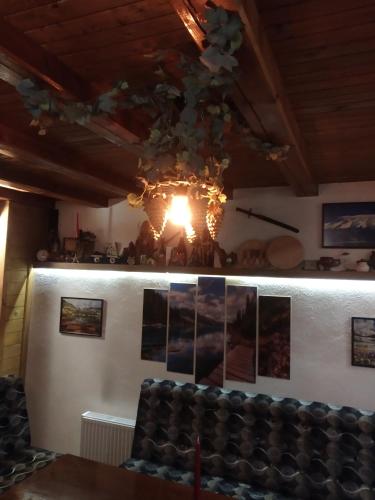 a chandelier hanging from a ceiling in a room at NIKI HOUSE in Bansko
