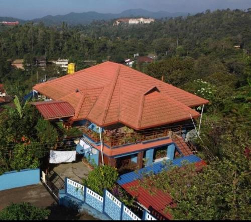 an overhead view of a house with an orange roof at Hill View Homestay Madikeri Coorg 3BHK Villa in Madikeri