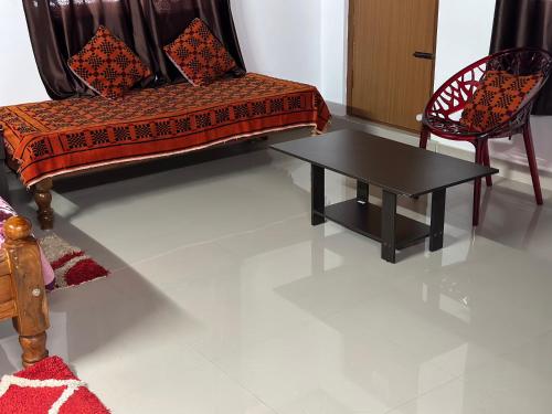 a living room with a couch and a table at Hill View Homestay Madikeri Coorg 3BHK Villa in Madikeri