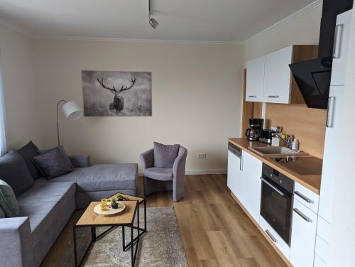 a living room with a couch and a table at Fewo Ettelsberg Niedersfeld in Winterberg