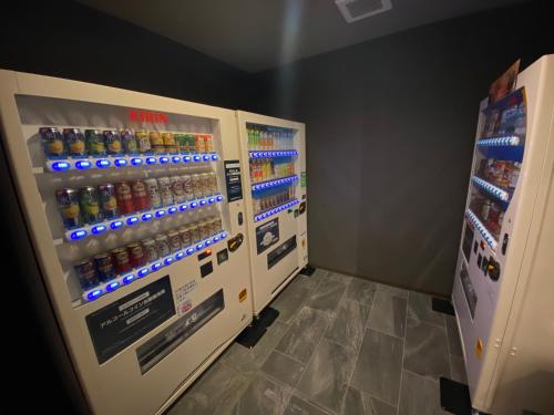 two vending machines in a store with drinks at Hotel Route Inn Osaka Izumifuchu in Izumi