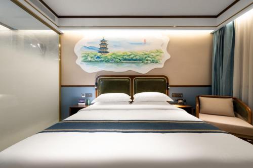 a bedroom with a bed and a painting on the wall at Nost algia S Hotel Hangzhou West Lake & Lingyin Temple 时光漫步S酒店杭州西湖店 Free laundry service, Free fresh ground coffee in Hangzhou