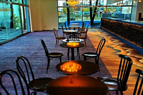 a row of tables and chairs in a restaurant at Sokcho Gallery In Stay in Sokcho