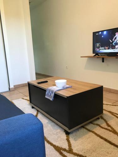 a coffee table in a living room with a tv at Le Studio Cosy II - Sainte Clotilde in Saint-Denis