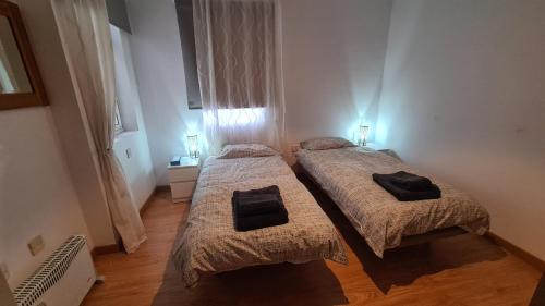 two beds in a small room with lights on at Gibraltar Town Centre Flat with Roof Terrace in Gibraltar