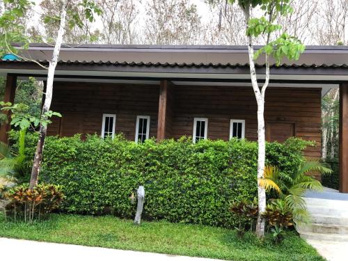 a statue of a man standing in front of a house at Nao Ta Chuang in Thung Song